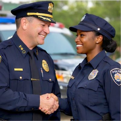 Police chief shaking hands with a new recruit, symbolizing mentorship and the beginning of a law enforcement career.